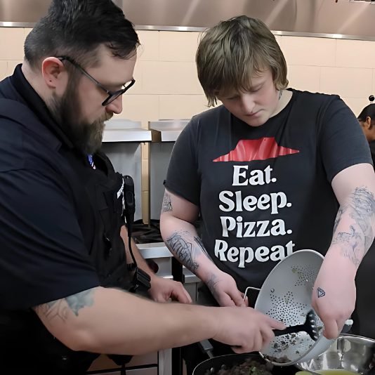  SRO and student cook together in class